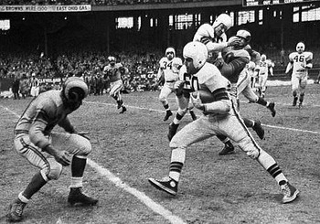Hall of Fame quarterback Otto Graham tries to avoid a Ram defende in the 1950 NFL Title Game.