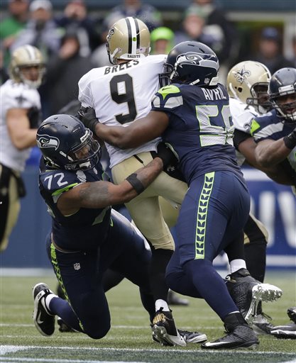 Michael Bennett & Cliff Avril sandwich Drew Brees amid the din of Qwest Field.